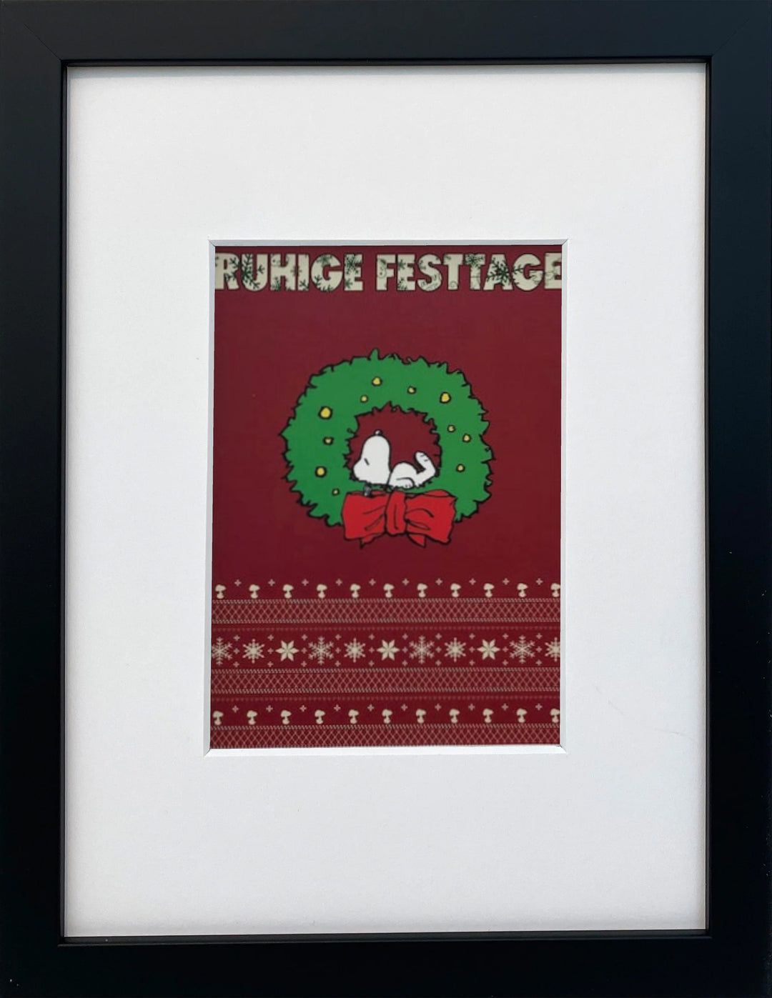 UNICEF-Karte „Ruhige Festtage“ mit Snoopy im Weihnachtskranz als gerahmter Miniprint im schwarzen Holzrahmen